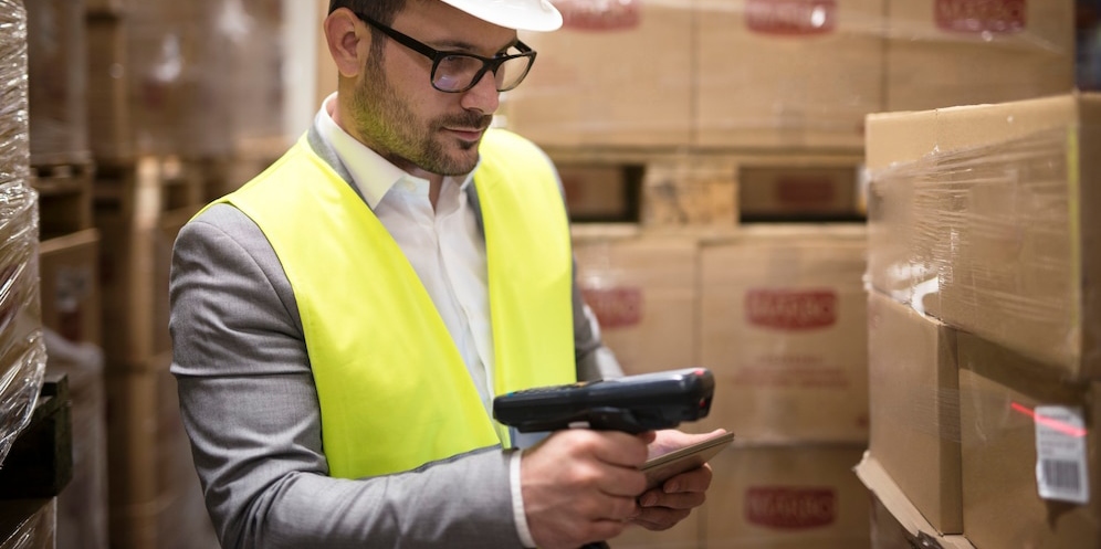 warehouse worker checking parcels with bar code re
